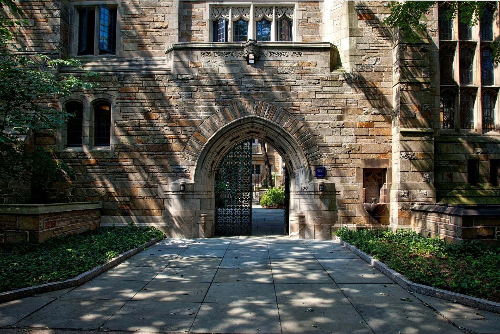 A stone archway leads to the entrance of a building