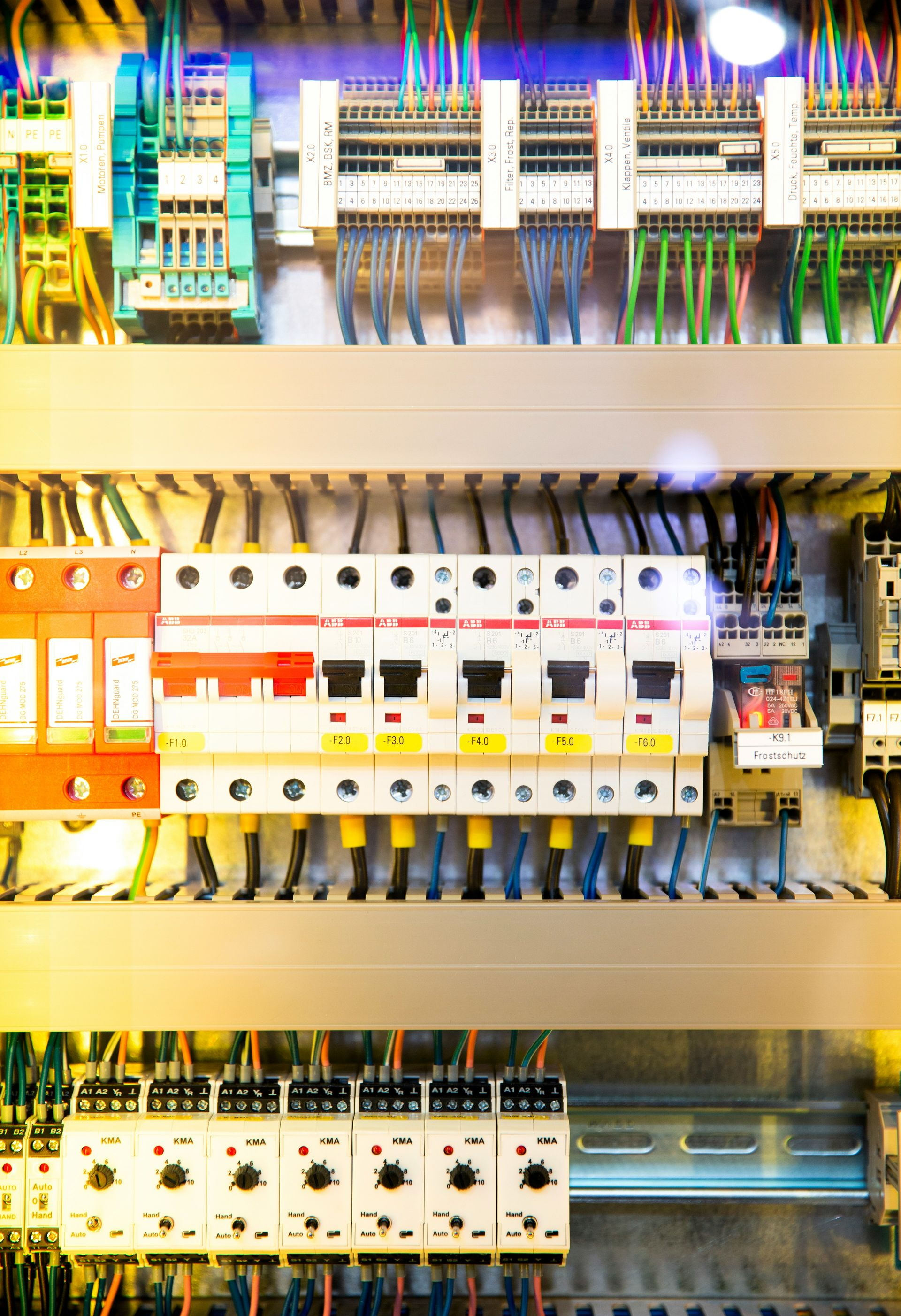 Electrical control panel with wires and circuit breakers.