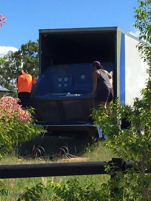 Man Pulling out the Jacuzzi on the Delivery Truck — Transportation in Hervey Bay, QLD