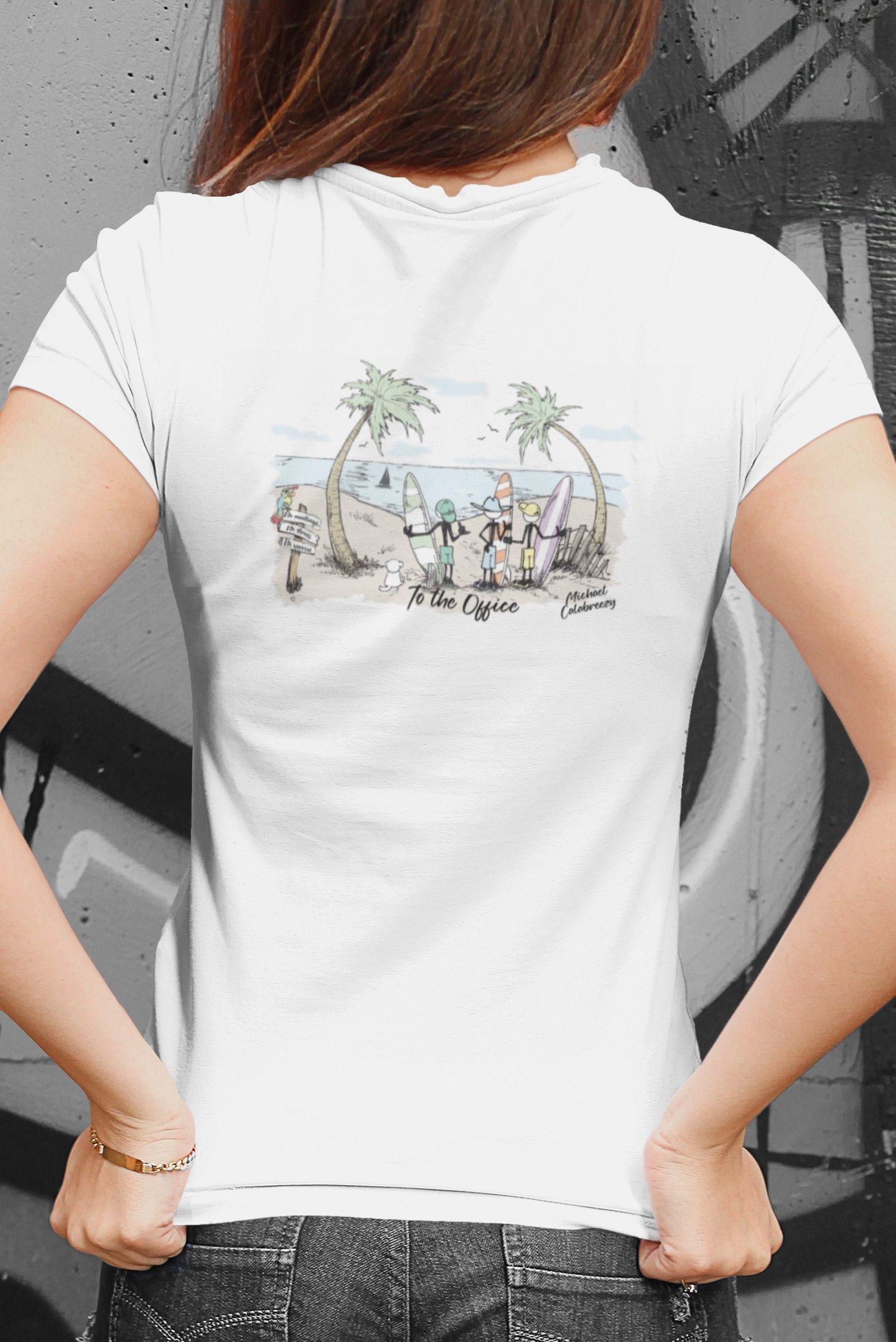 Woman in white t-shirt with beach scene print on back, hands in front. Graffiti background.