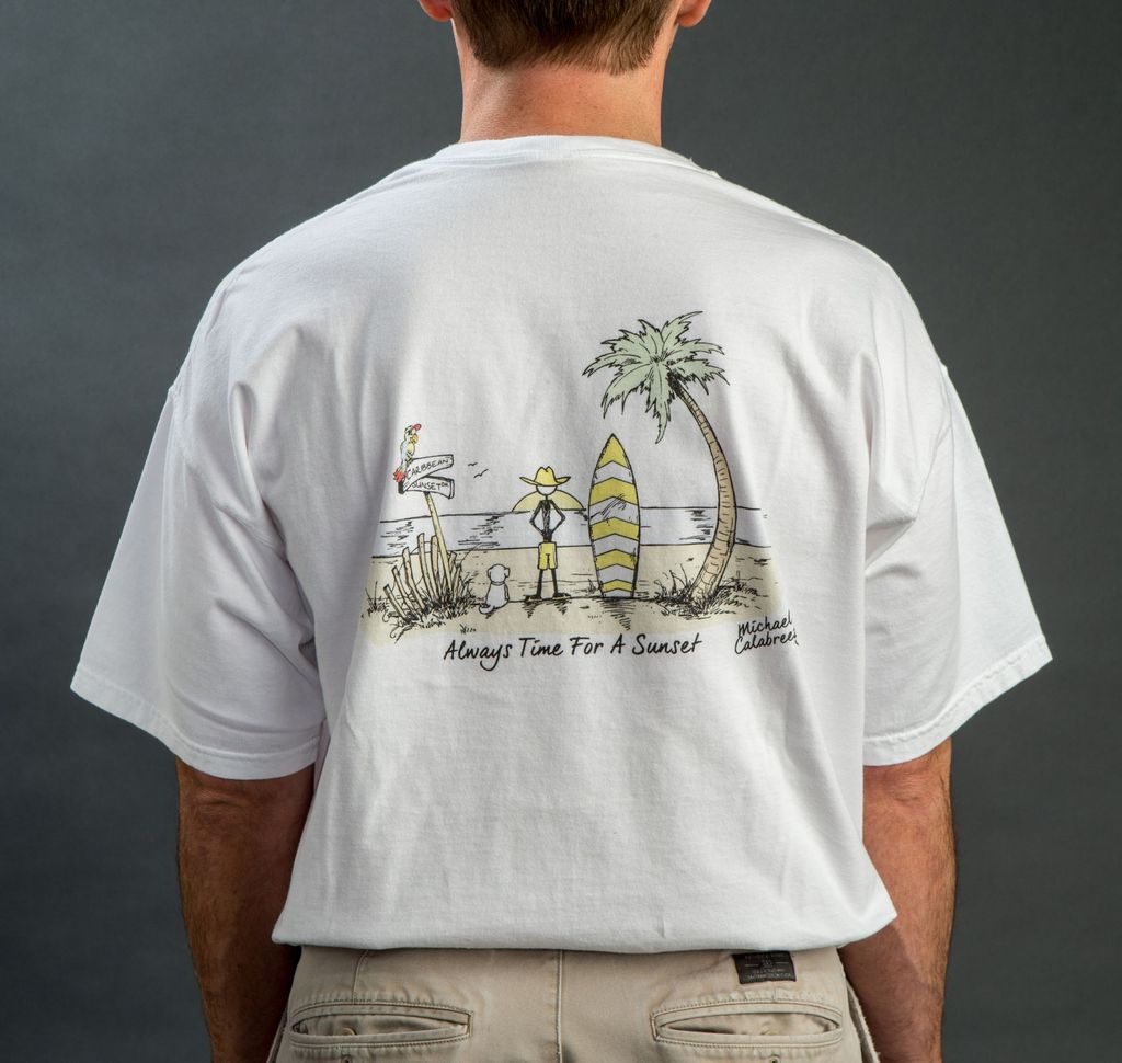 Two people on a beach wearing white t-shirts with cartoon graphic and text.
