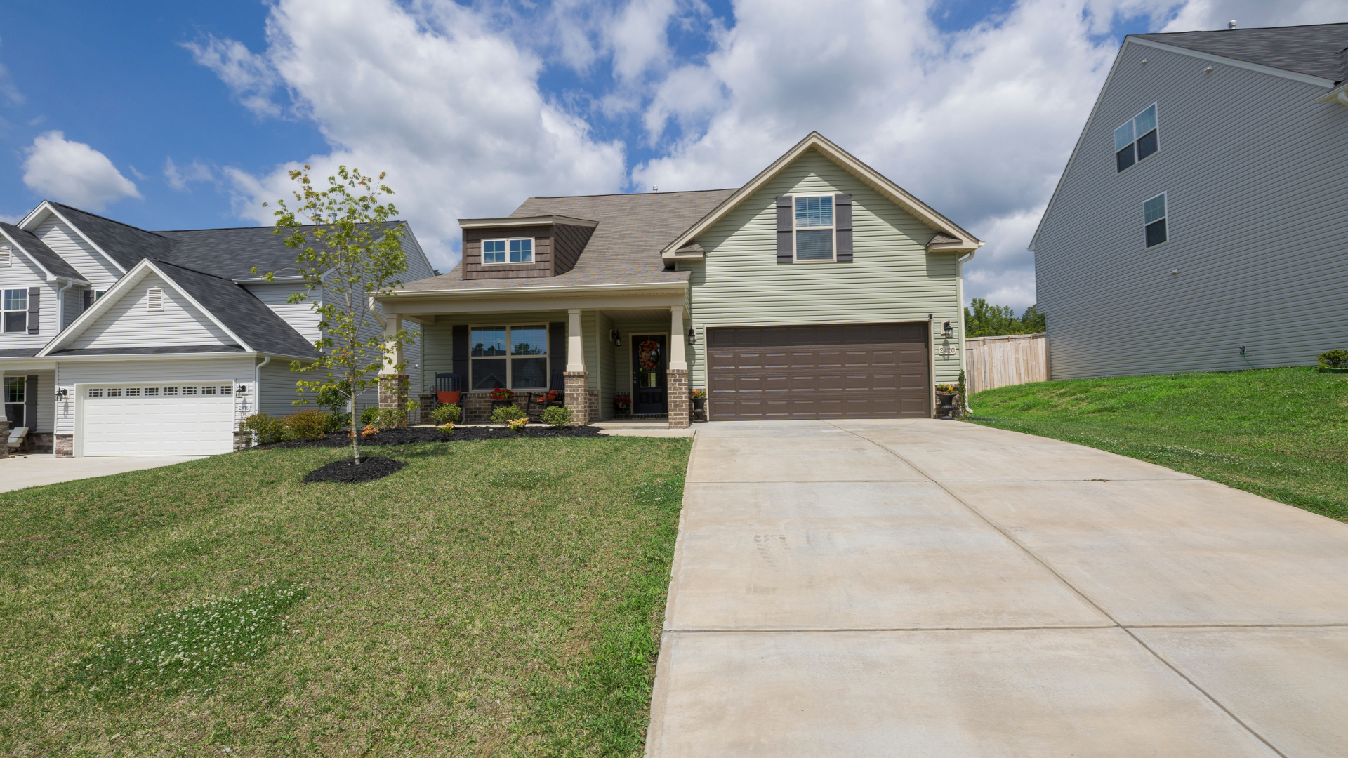 A house with a concrete driveway leading to it