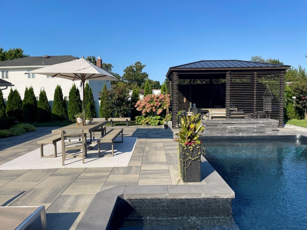 A patio area with a swimming pool and a gazebo
