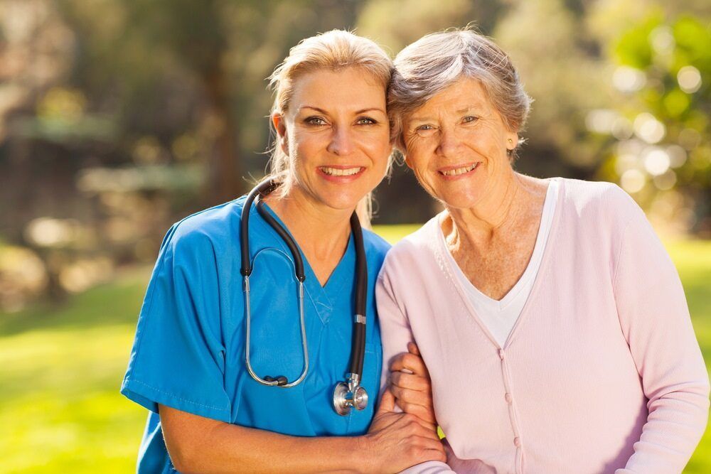 A Nurse is Hugging an Elderly Woman in a Park — TPF Industries in Rural View, QLD
