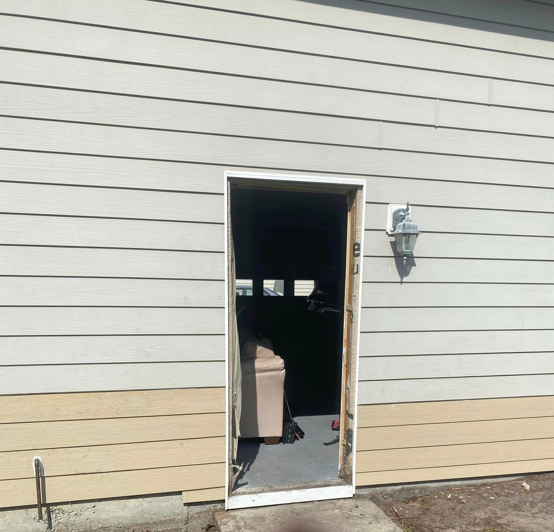 A door that is open to a room with a couch in it