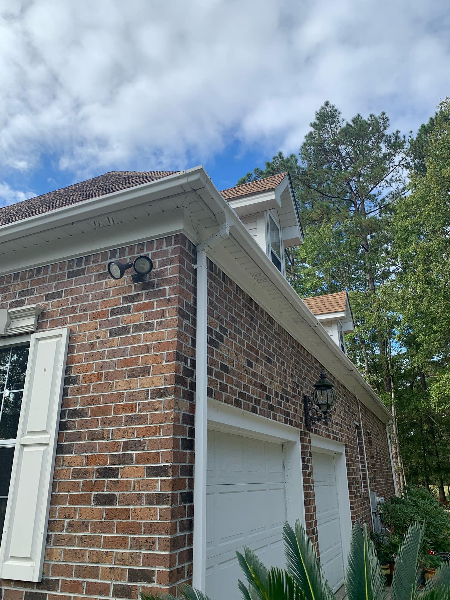 A brick house with a flag in front of it.