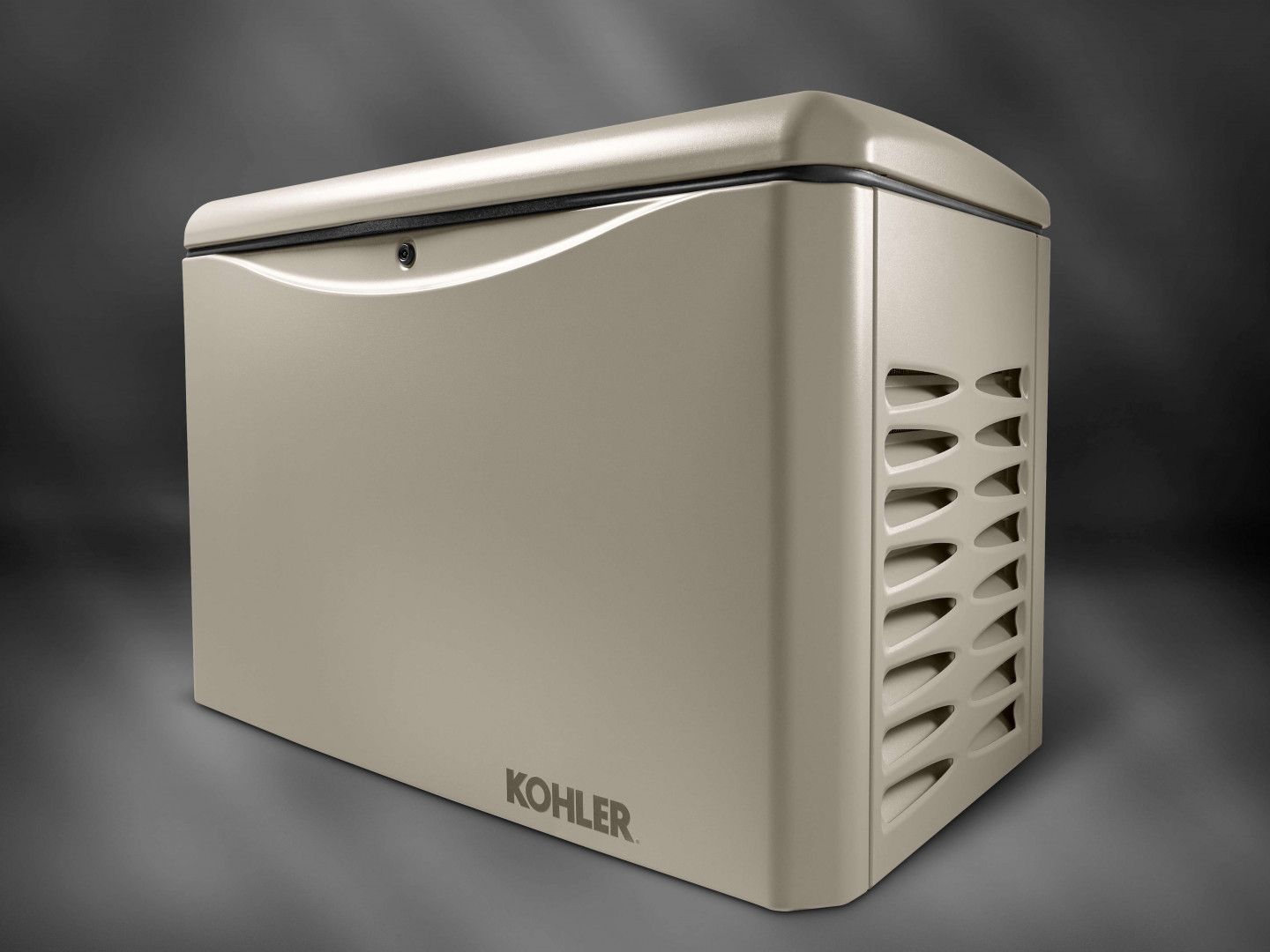 A beige Kohler home standby generator with a curved top and louvered side panels.