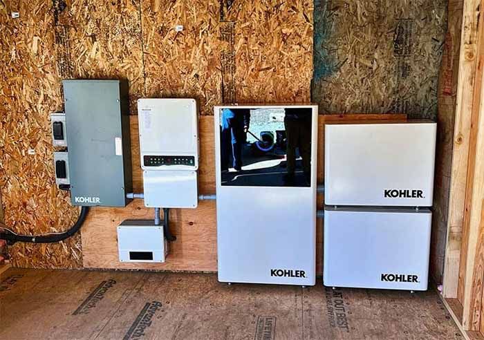 Electrical equipment mounted on wooden wall; includes Kohler branded boxes.