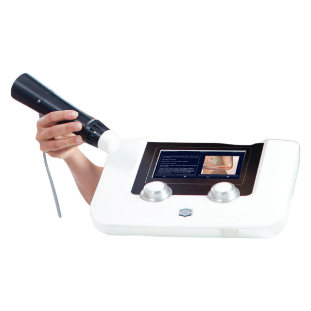 A person holding a medical device with a screen and a handpiece for therapeutic treatment.