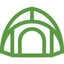 A green icon of a tent on a white background.