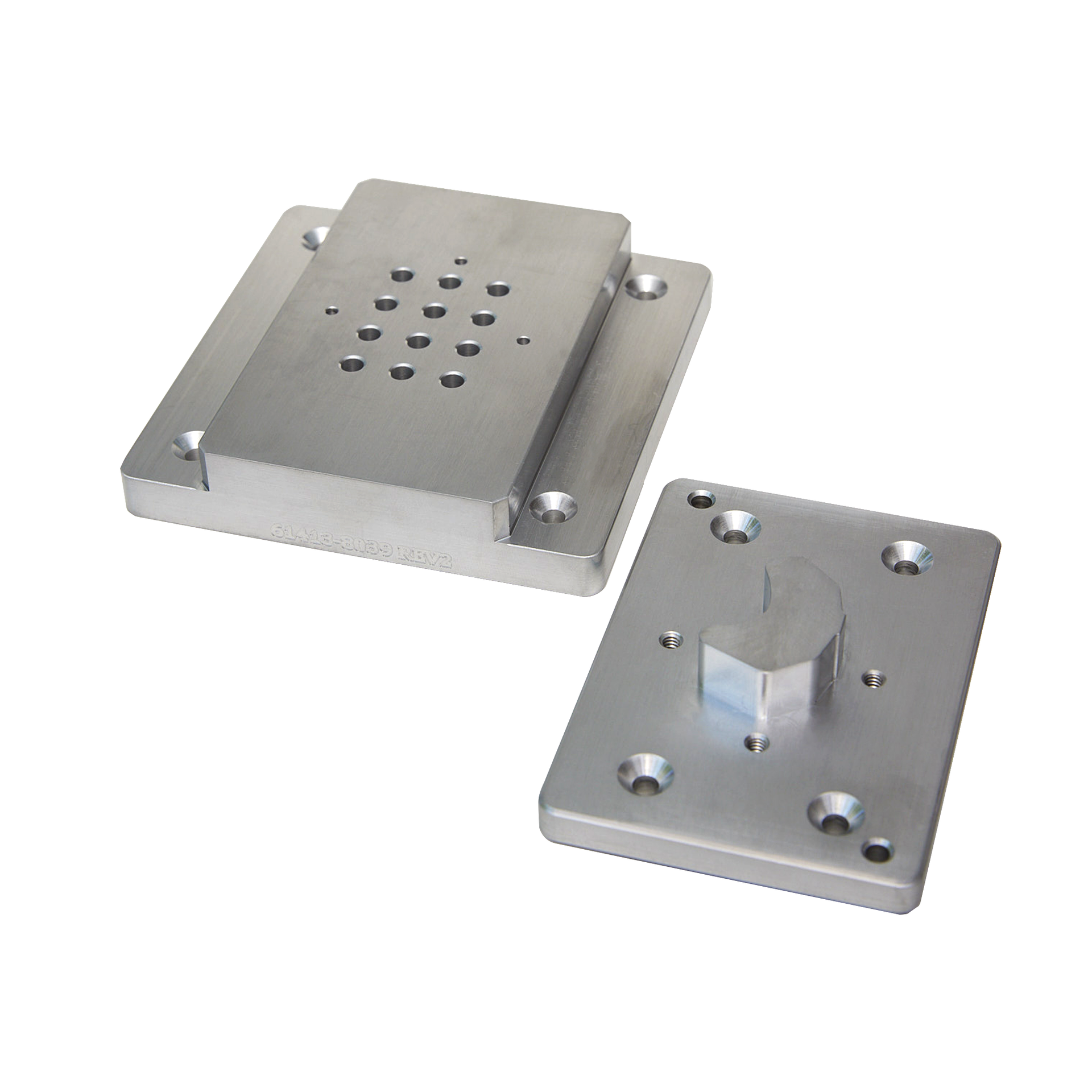 Two metal plates with holes in them on a white background