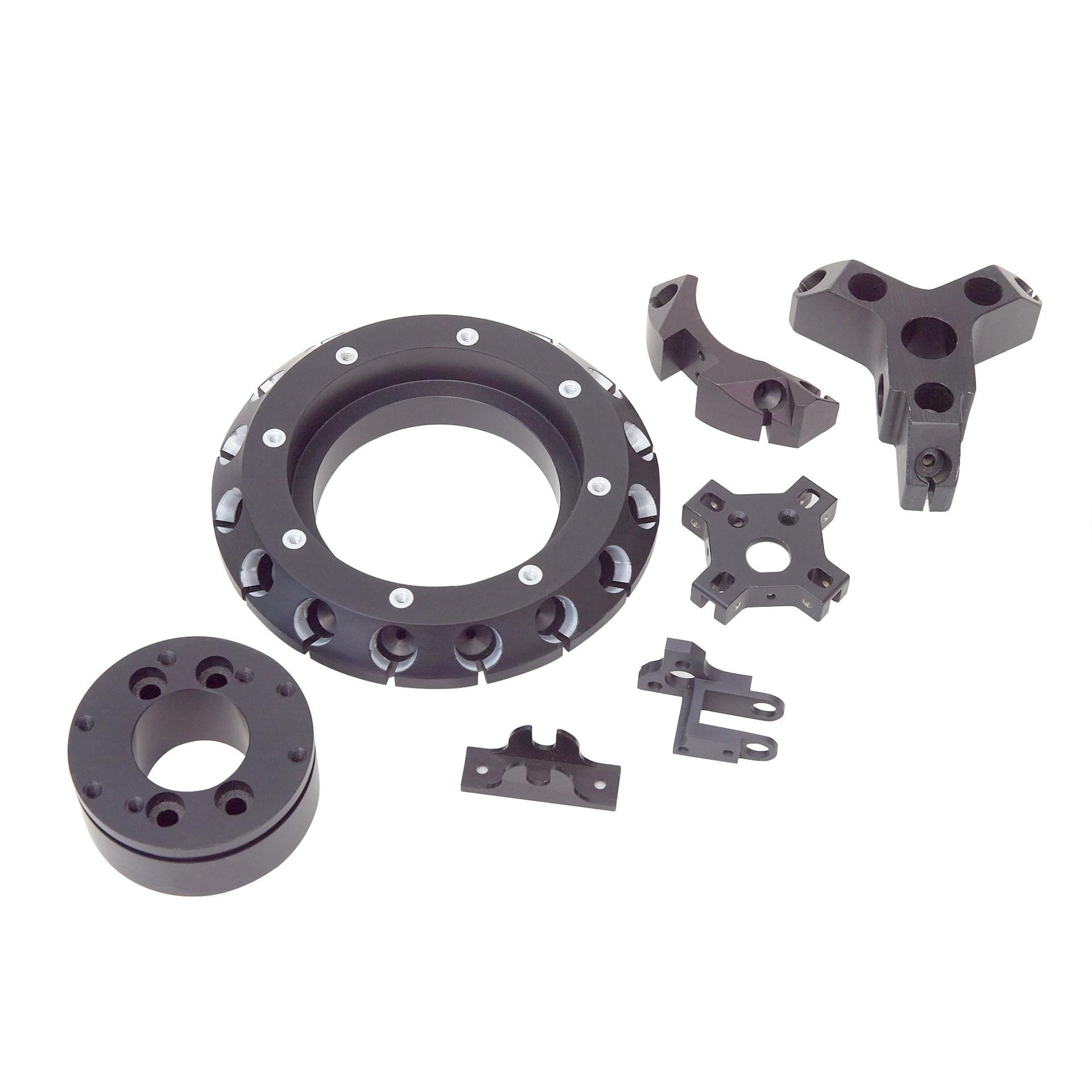 A bunch of black plastic parts on a white background