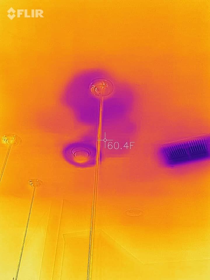 Thermal image of a ceiling showing heat leaks around lights and a vent, with a temperature reading of 150.41.