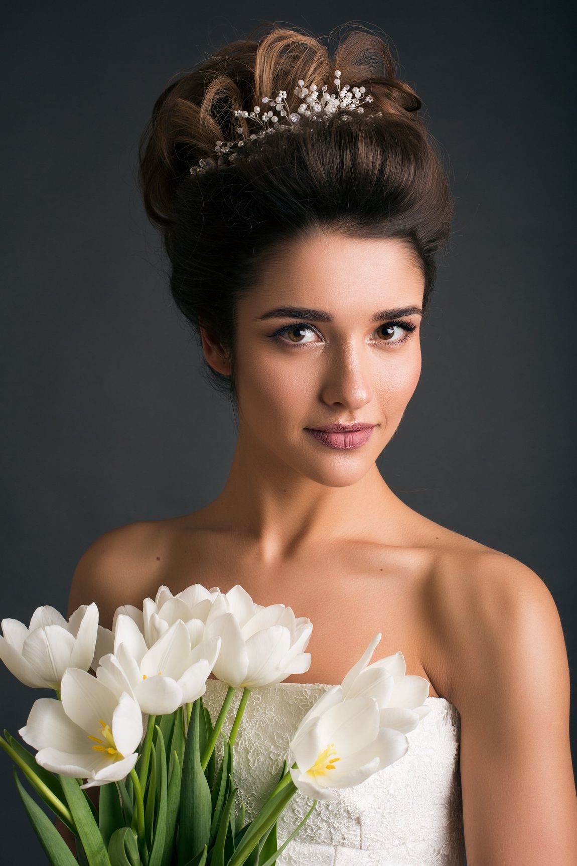 Woman wearing tiara holding tulips