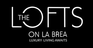 Logo for The Lofts on La Brea, white text on black background. "The Lofts" above "On La Brea" and "Luxury Living Awaits".