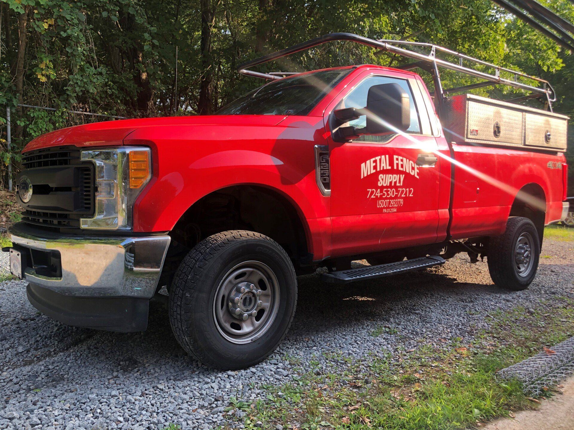 property territory fencing - man screws metal fence panel