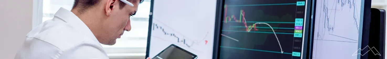 A group of people are sitting around a table talking to each other.