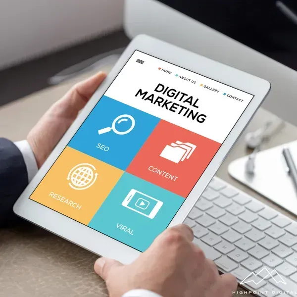A person is holding a tablet that says digital marketing on it