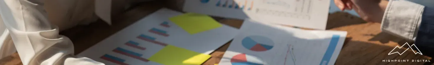 A group of people are sitting around a table talking to each other.