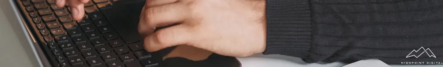 A person is typing on a laptop computer.