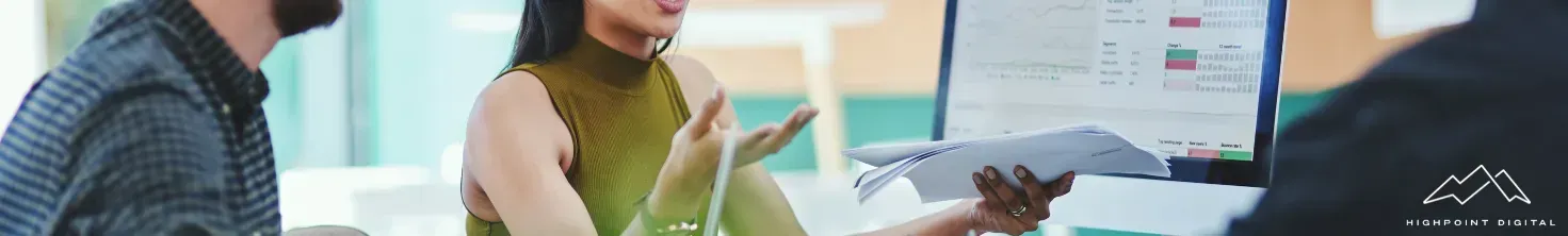 A person is writing on a piece of paper with a pen.