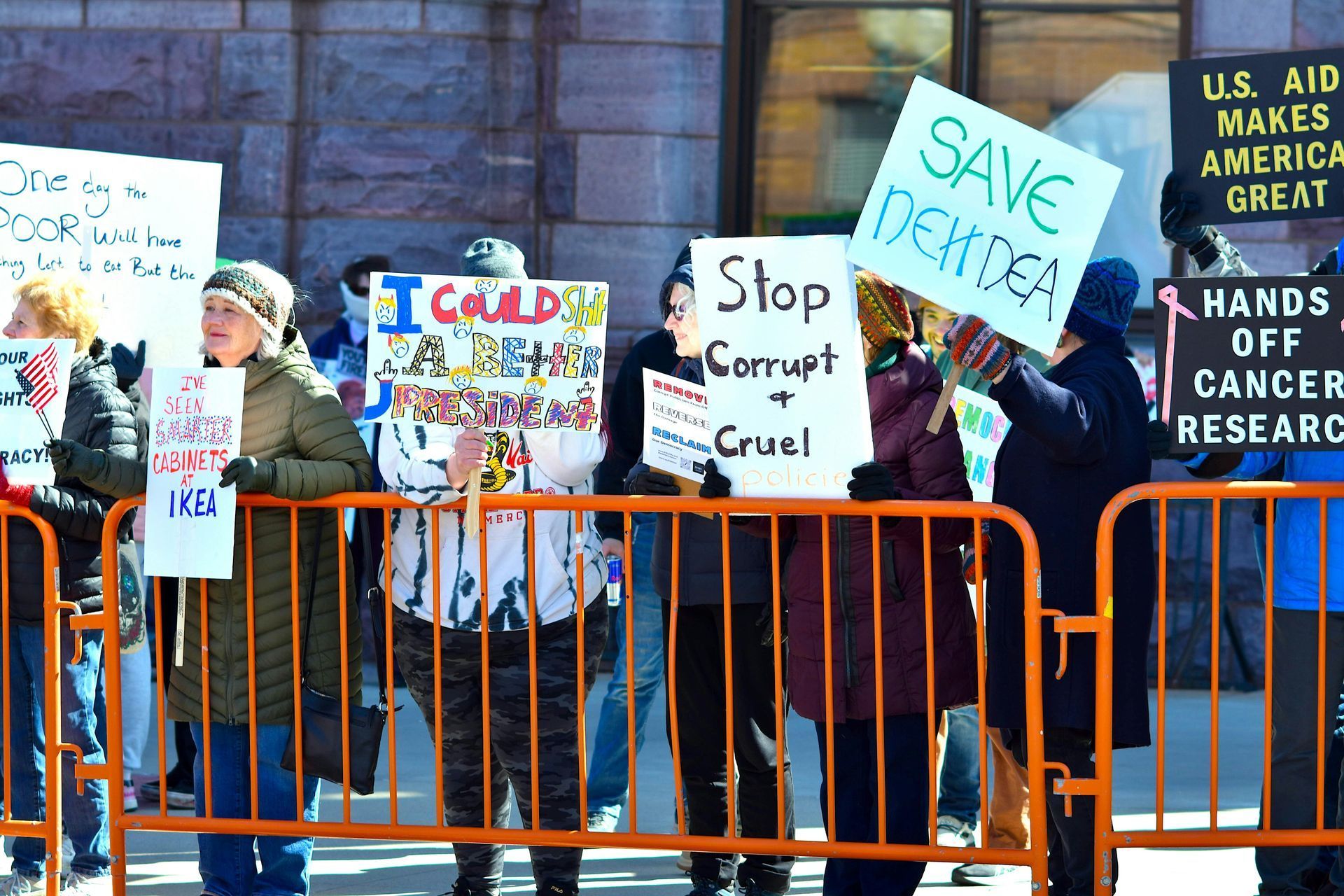 A group of people holding signs including one that says save derdea