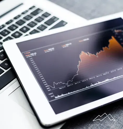 A tablet with a graph on it next to a laptop