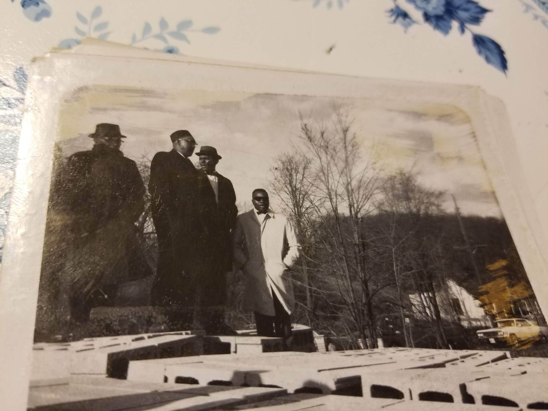 A black and white photo of three men standing next to each other