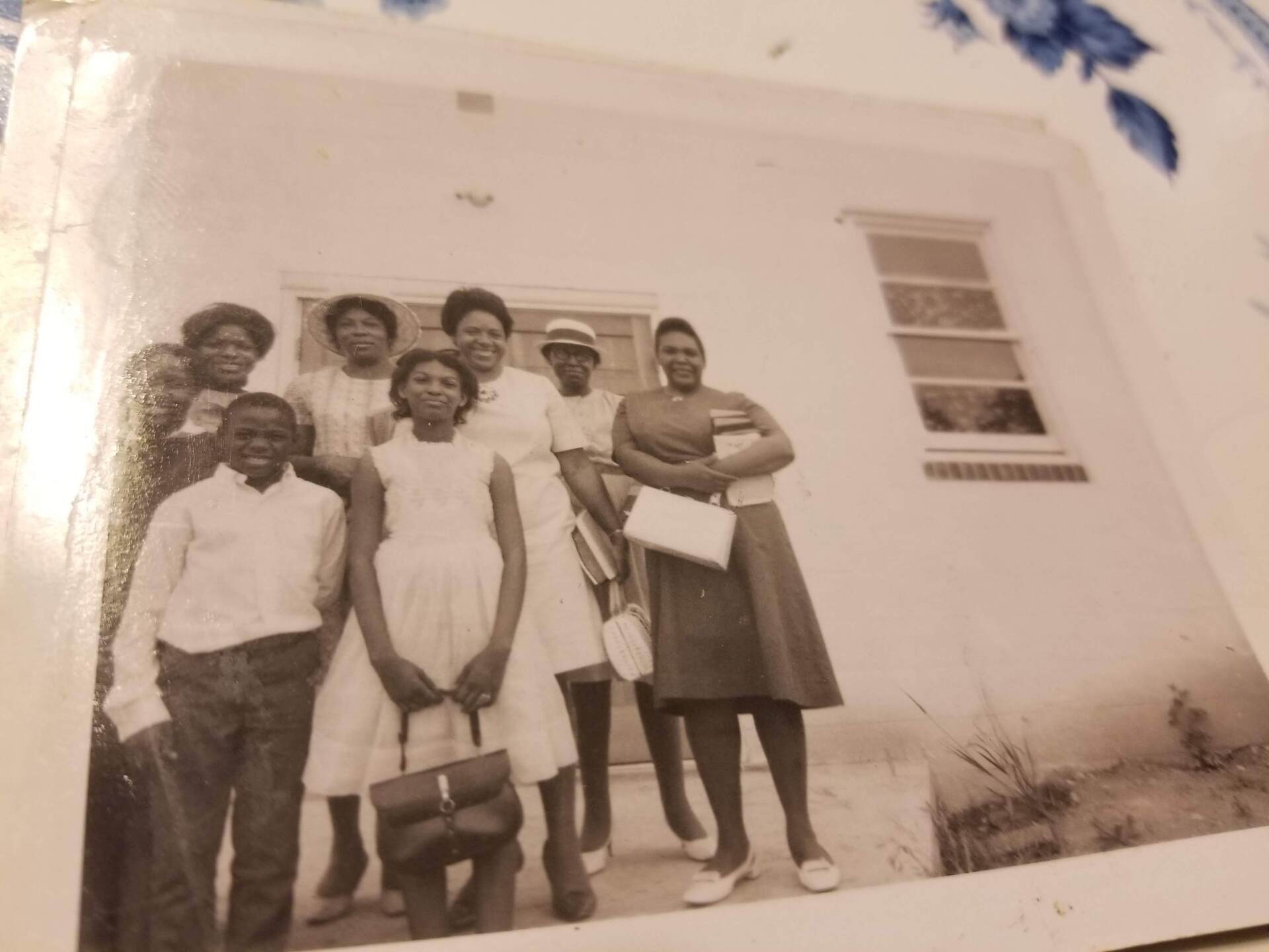 A group of people standing in front of a white building