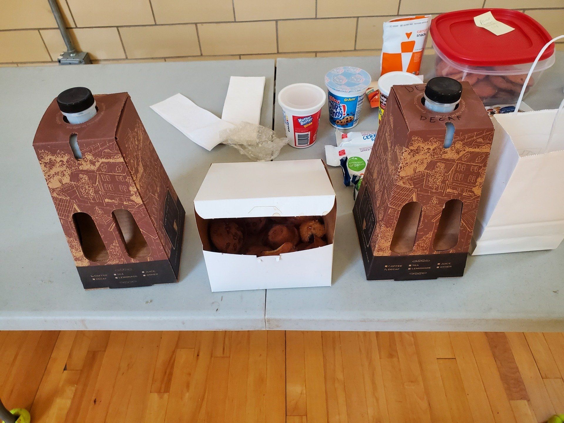 Three boxes of donuts are sitting on a table