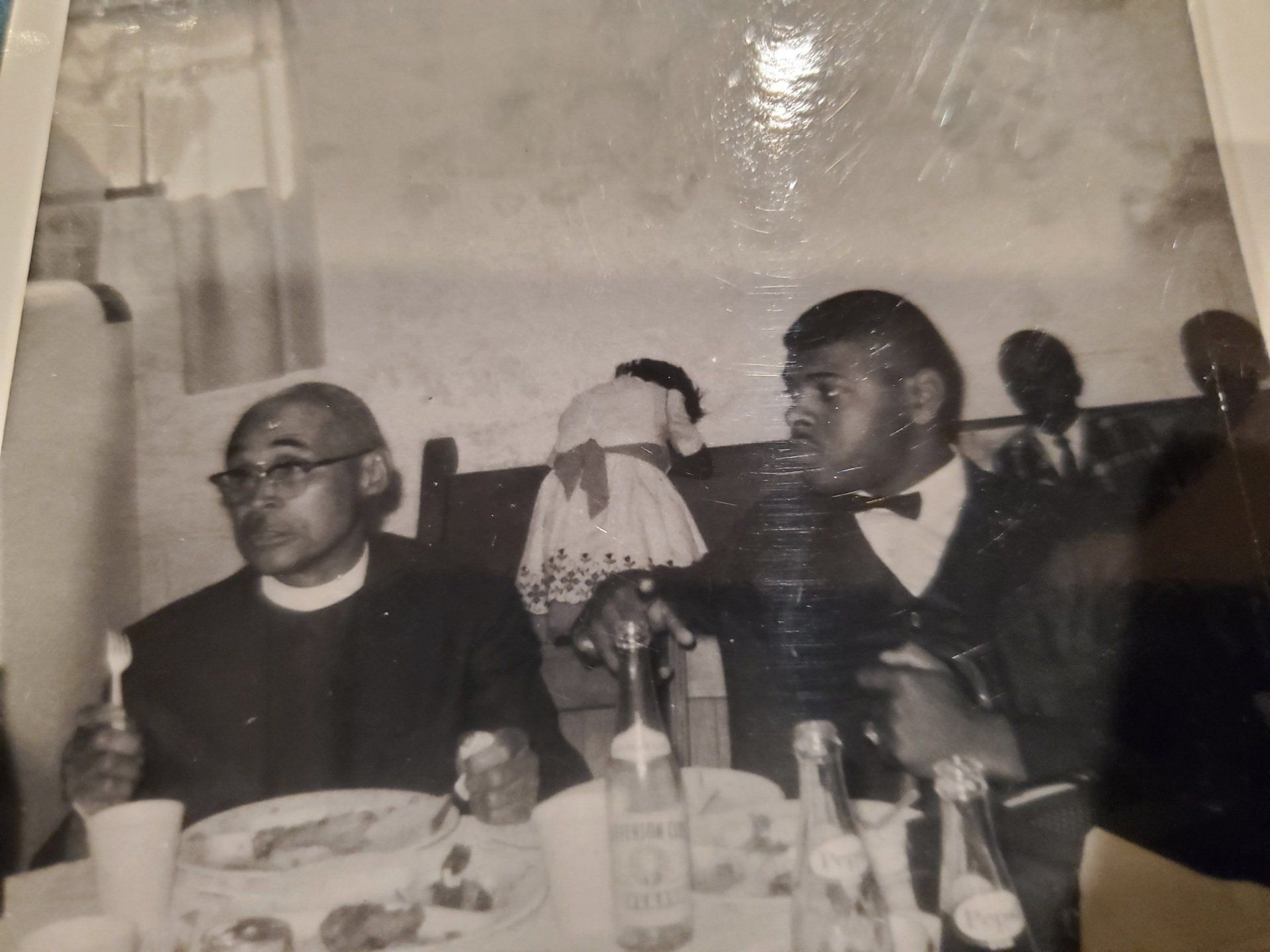 A black and white photo of two men sitting at a table
