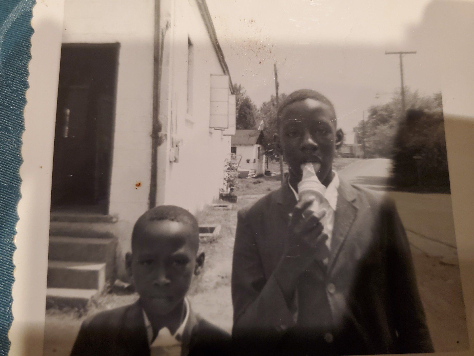 A black and white photo of two boys eating ice cream