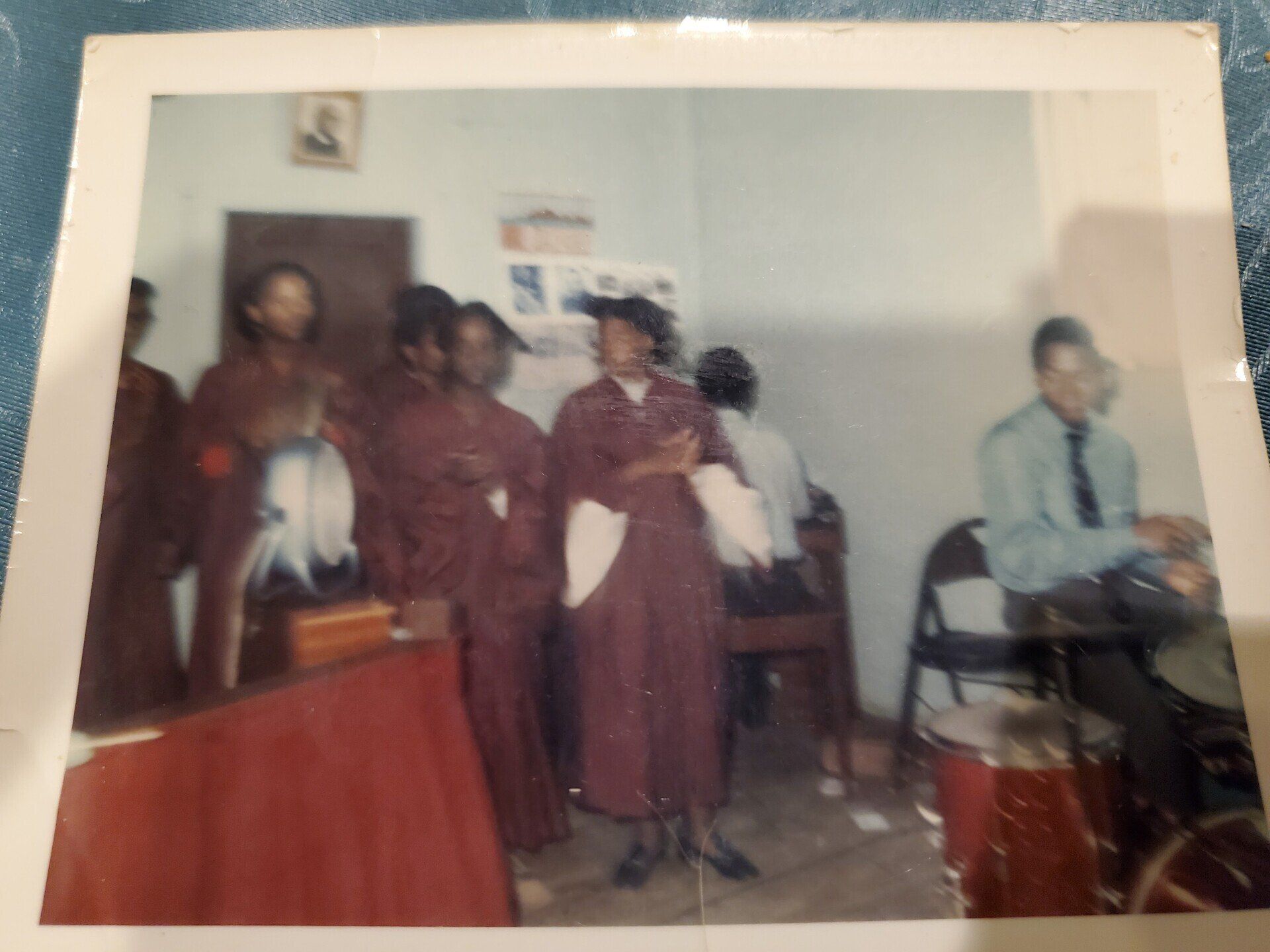 A group of people standing in a room with the number 8 on the wall