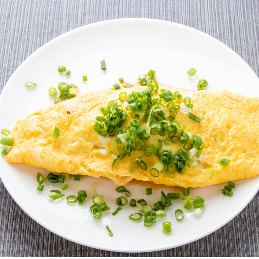 A plate of food with mashed potatoes green beans and chicken on a table.