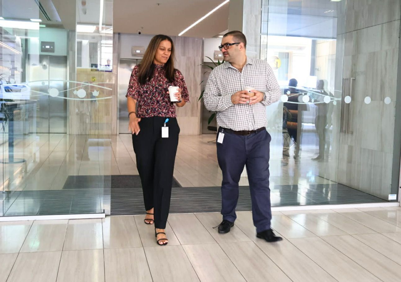 A large office building with a lot of windows on a sunny day.