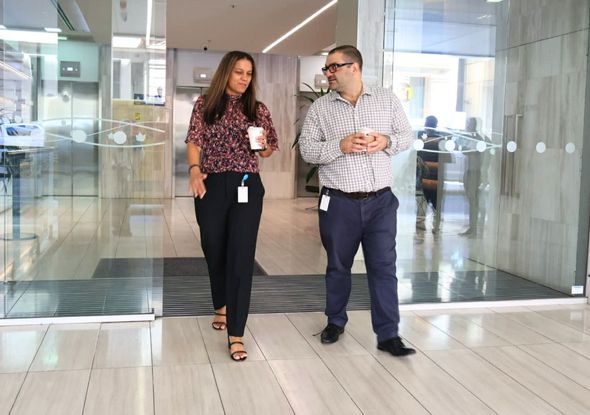 A large office building with a lot of windows on a sunny day.