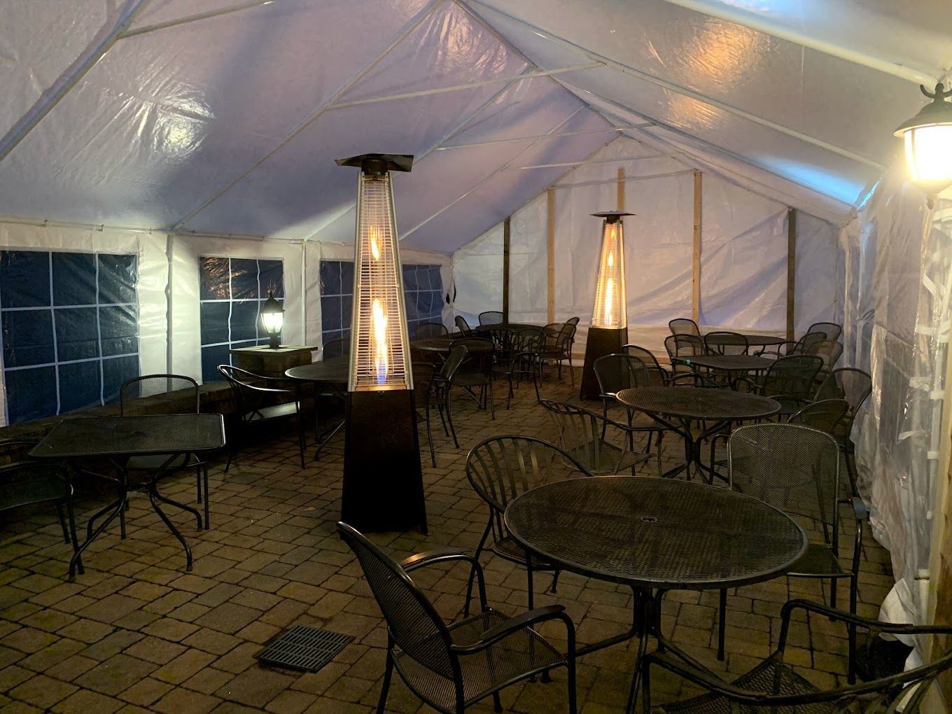 A large tent with tables and chairs inside of it