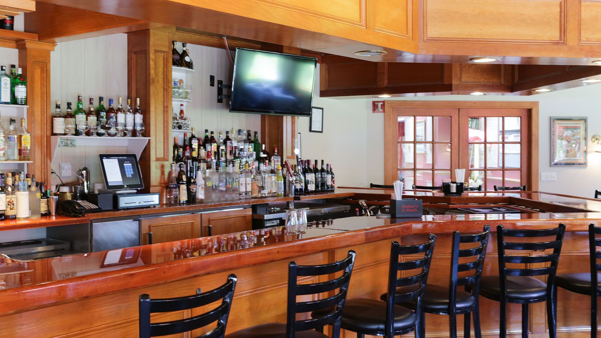 A bar with a lot of bottles of liquor on it