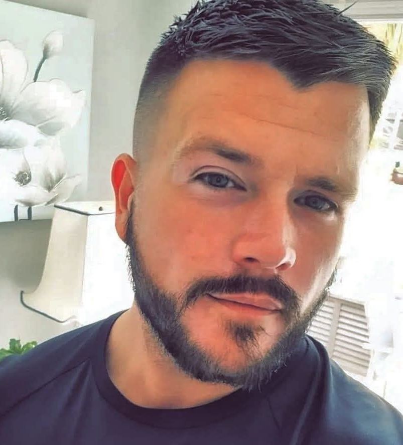 Luke Bennett with a beard and mustache is wearing a black shirt. LB Plumbing and Heating Wrexham