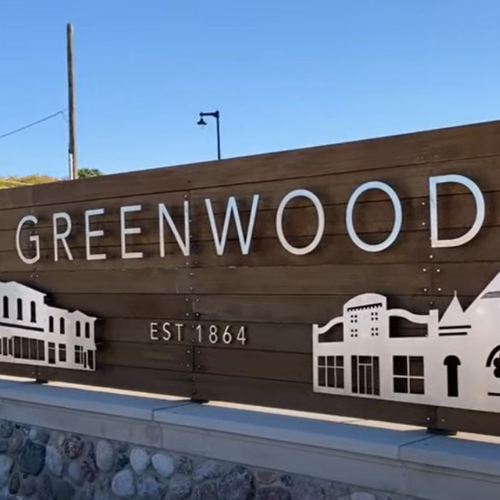 A wooden sign that says greenwood on it
