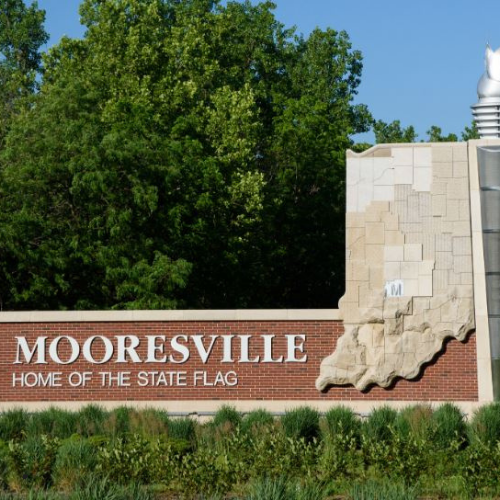 A sign that says Mooresville home of the state flag