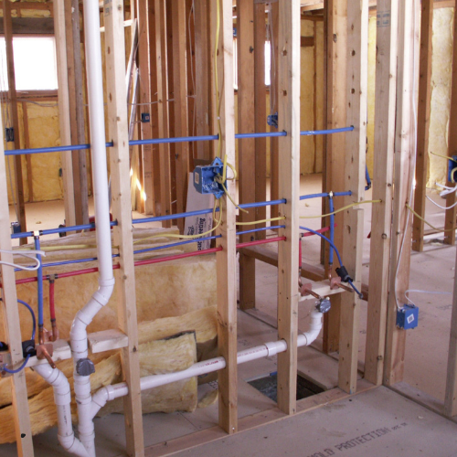 A room with a lot of pipes and wires in it
