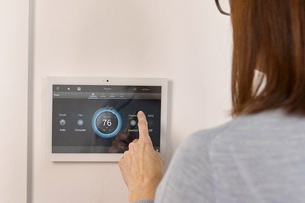 Person using smart home device — Cerritos, CA — Southern California Security Centers Inc