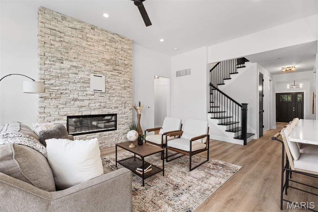 A living room filled with furniture and a fireplace.