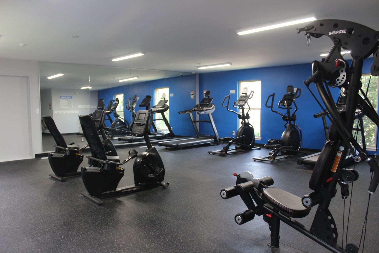 A large gym with a lot of exercise equipment