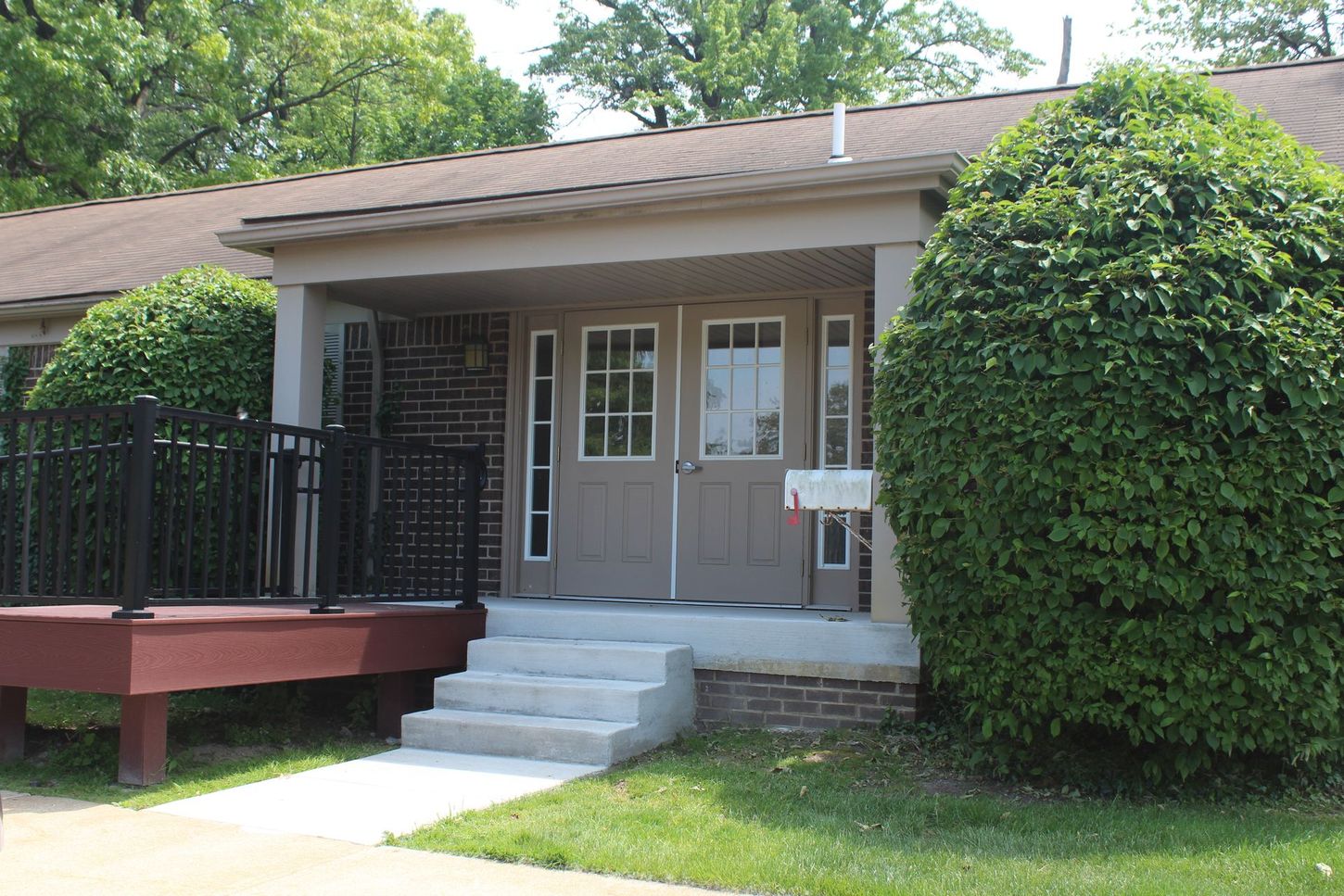 A small house with a porch and stairs