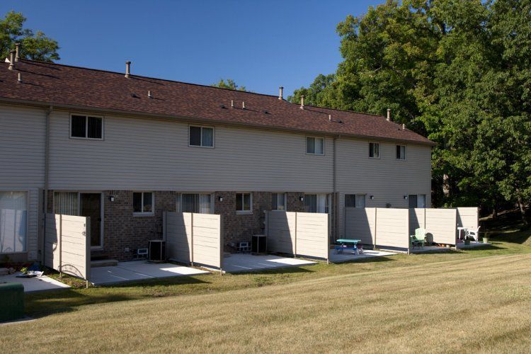 A row of houses with a picnic table in front of them