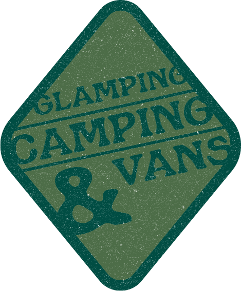Green diamond-shaped sign with the words “Glamping, Camping & Vans” in dark lettering