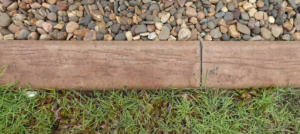Kerbing Along Grass and Rocks — Landscaping in Palmerston, NT