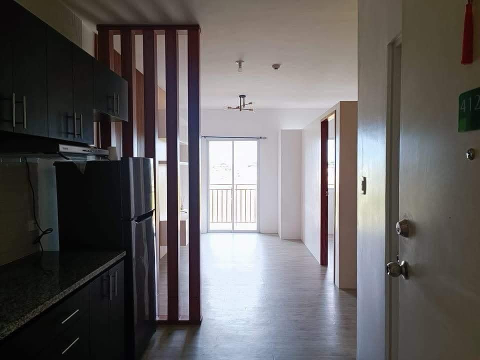 A kitchen with a refrigerator and a sliding glass door